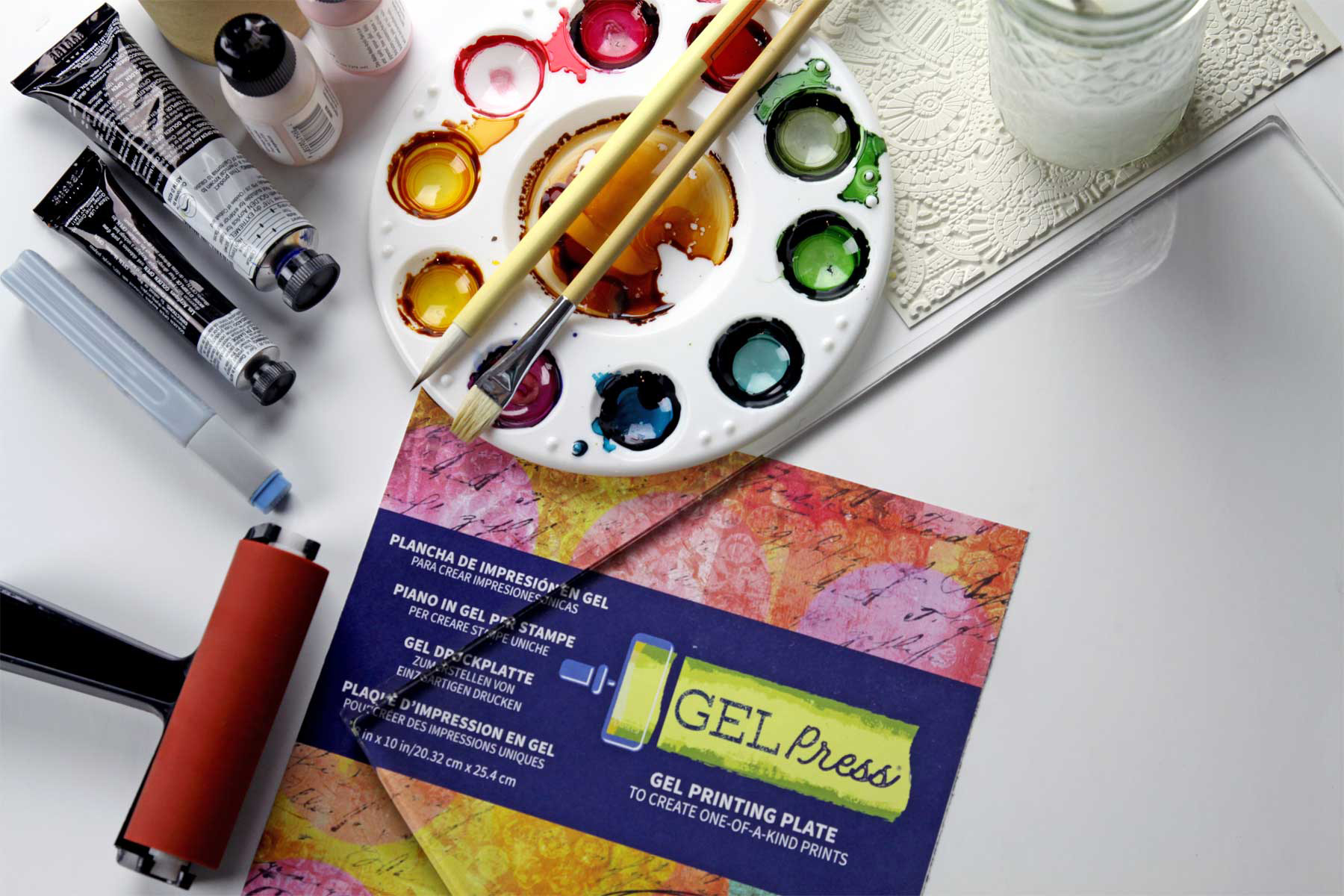 picture shows a gel press, brayer and art materials